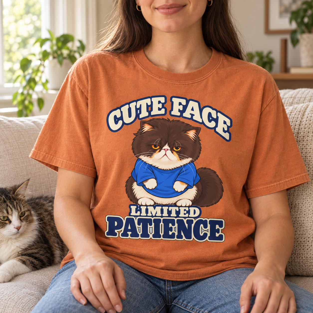 Woman wearing the Cute Face Limited Patience tee with a cat beside her